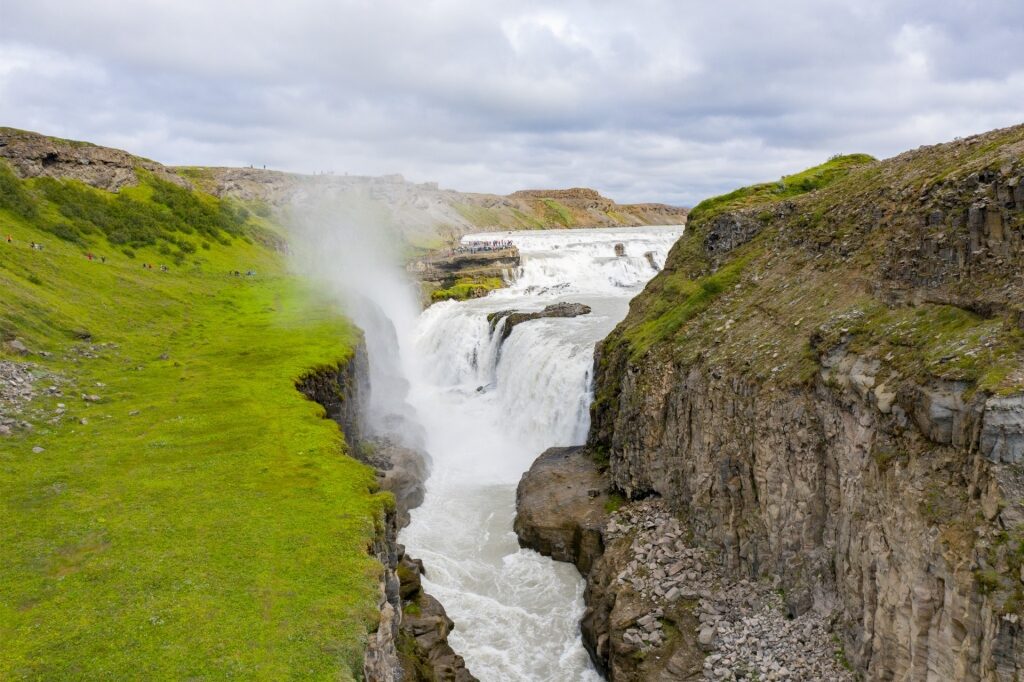 Scenic view of Gullfoss waterfall surrounded by rocky Icelandic landscape