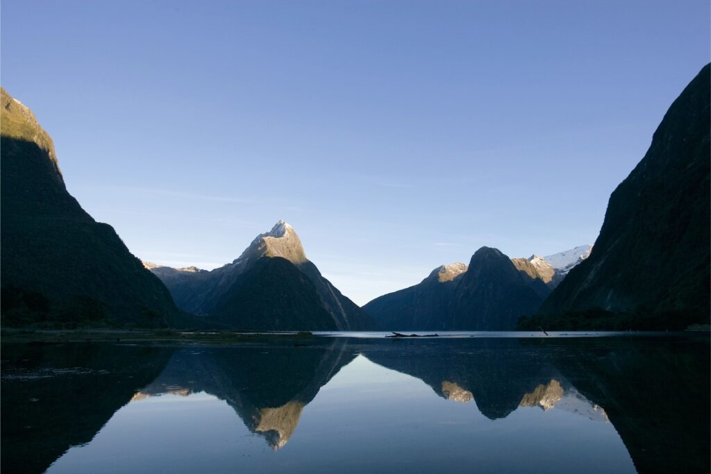 Scenic view of Milford Sound mountains reflected on water in New Zealand