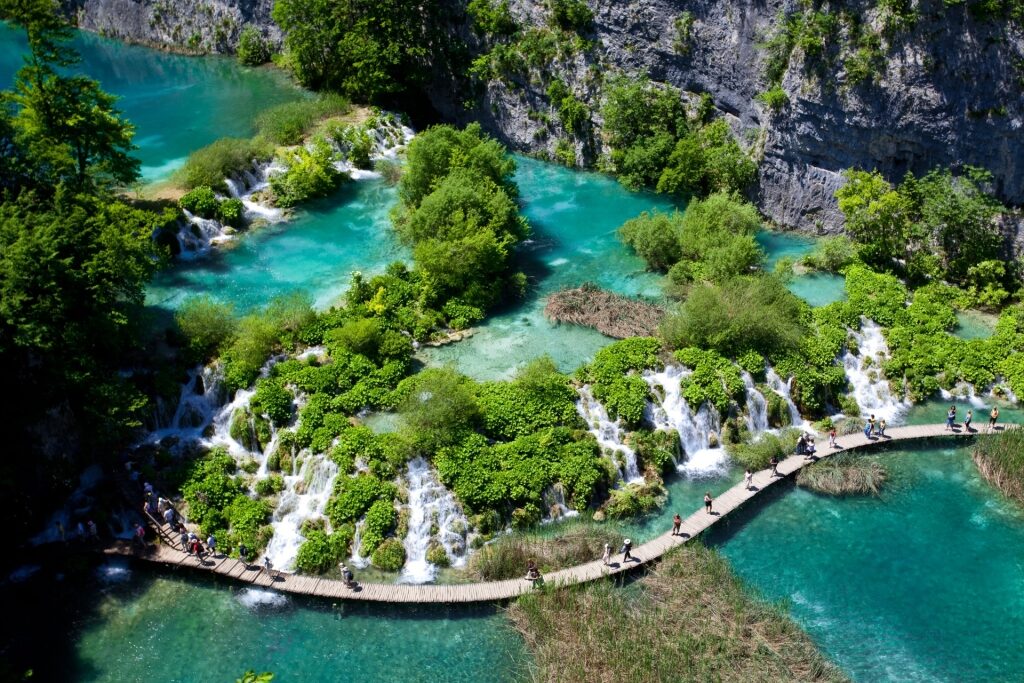 Wooden walkway over turquoise water at Plitvice Lakes National Park