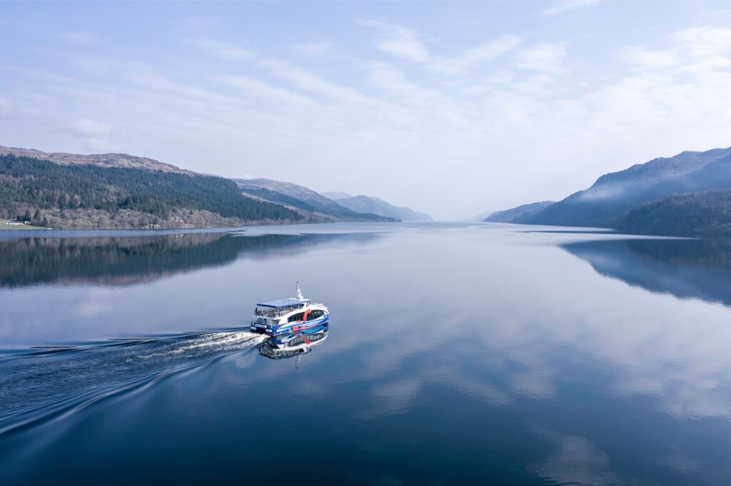 Tour boat cruising on Loch Ness in Scottish Highlands, Scotland