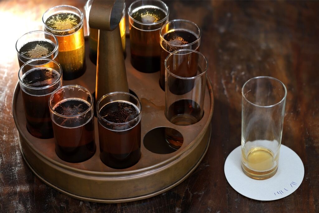 Round tray filled with tall glasses of Kölsch beer served in Cologne, Germany