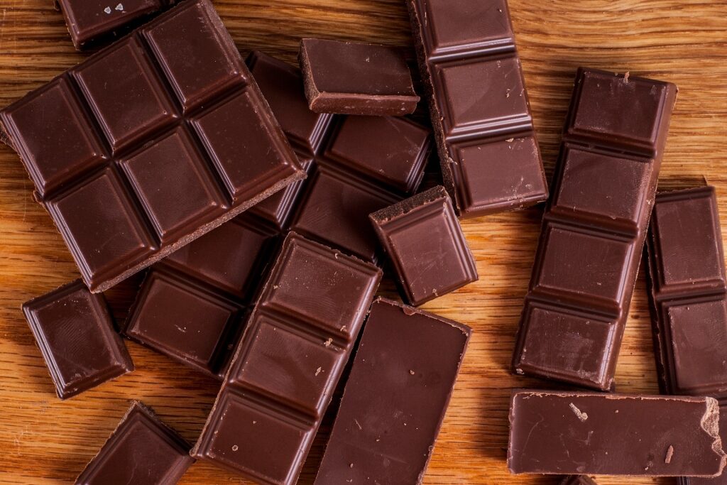 Milk chocolate pieces on a wooden surface