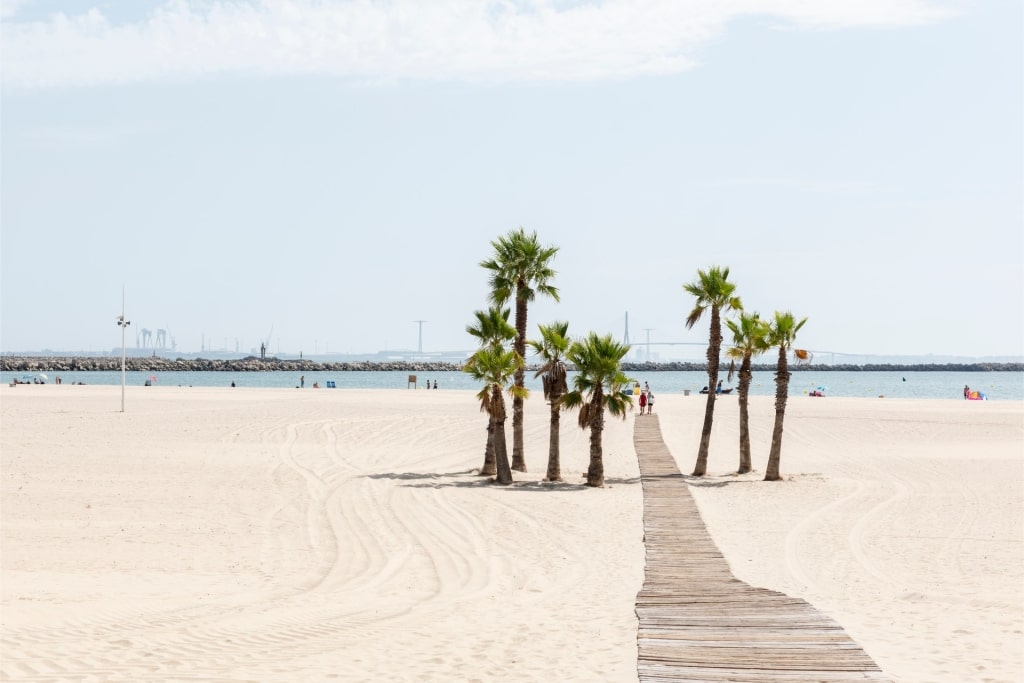 Scenic walkway along Playa de la Puntilla beach in El Puerto de Santa María, Spain