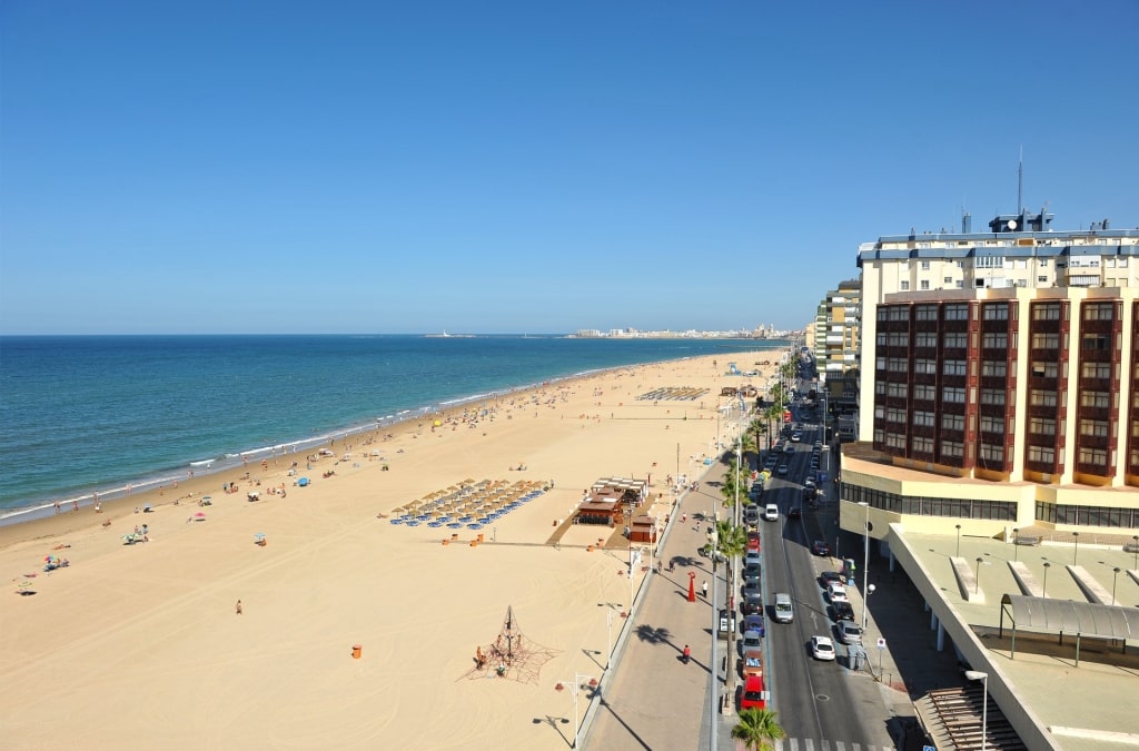 Promenade along Playa de la Victoria beach in Cádiz, Spain 
