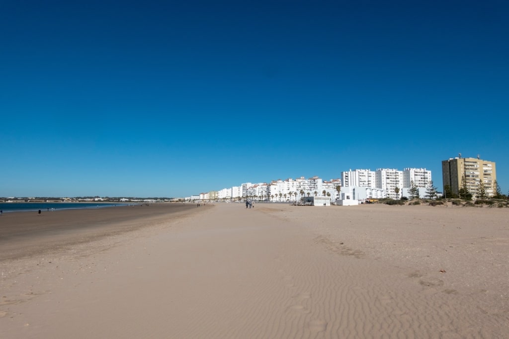 Playa de Valdelagrana beach in El Puerto de Santa María with white seaside buildings