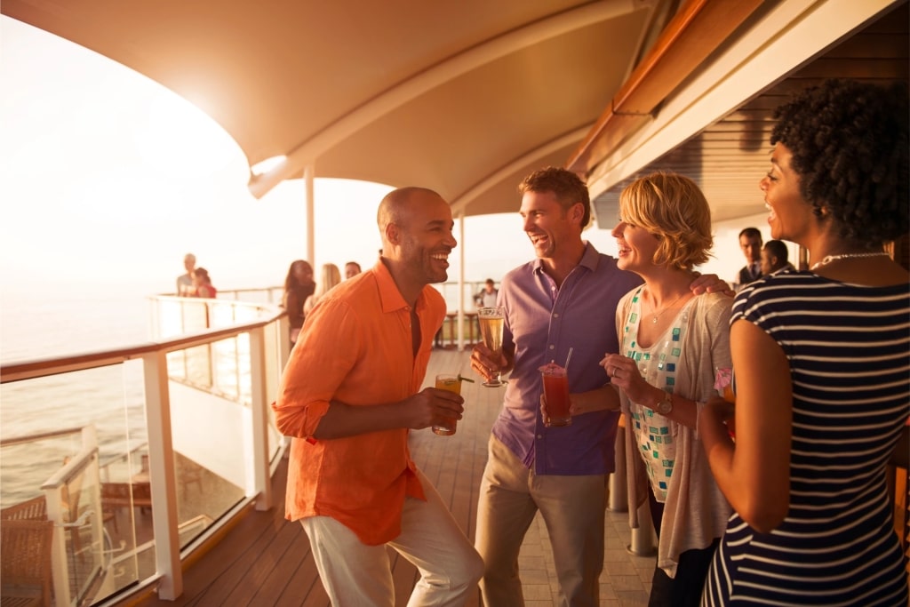 Friends laughing and relaxing at the Sunset Bar on a Celebrity Cruise ship