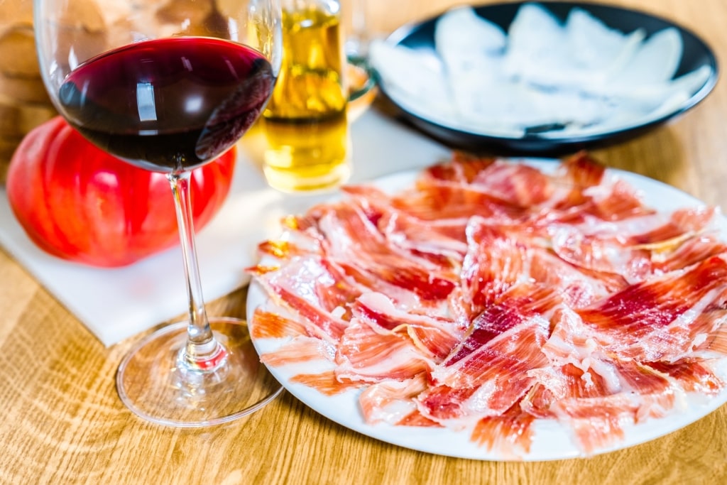 Plate of Jamón Ibérico served with red wine in Spain