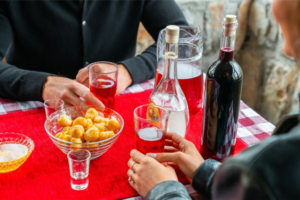 Traditional Montenegrin priganice fried dough balls with drinks