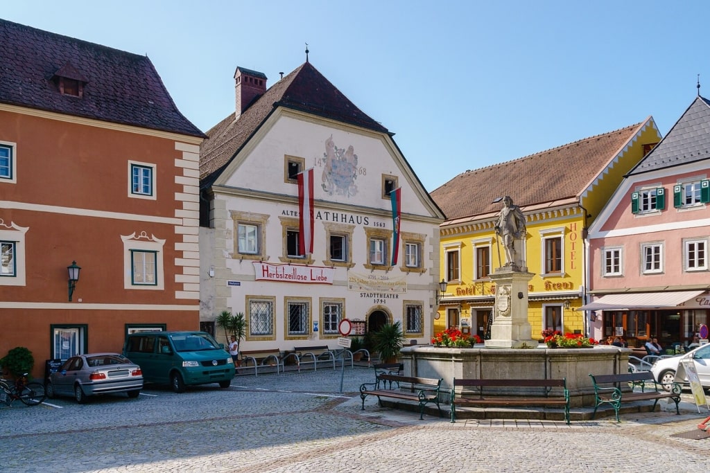Exterior view of historic Municipal Theater and the Meggau Fountain in Grein, Austria