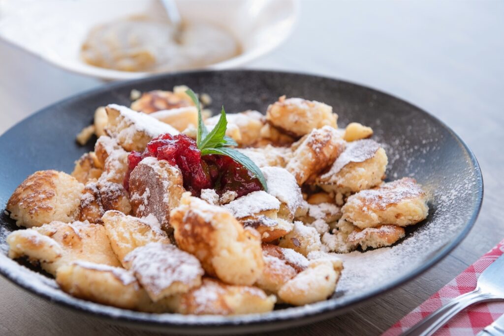 Kaiserschmarrn dessert on a plate dusted with sugar