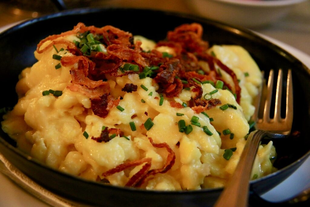 Close-up of creamy Kasnocke topped with crispy onions