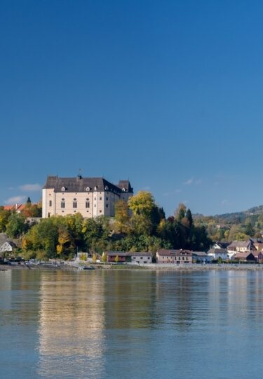 Riverside view of Greinburg Castle and old town of Grein, Austria
