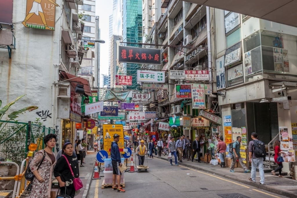 Busy street view in Hong Kong with colorful shop signs