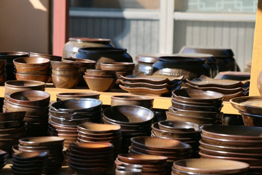 Onggi bowls, plates, and jars displayed in a Korean pottery shop