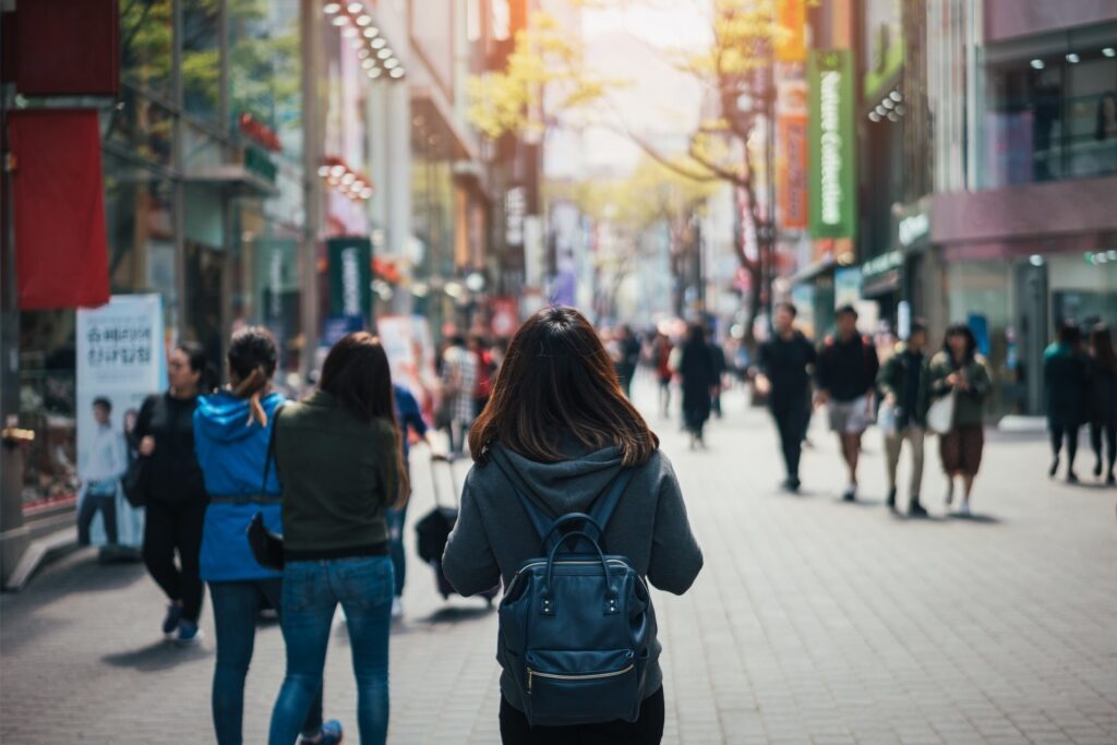 Tourist exploring Myeongdong shopping street in Seoul, South Korea