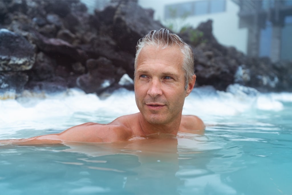 Tourist relaxing in Blue Lagoon, one of the most popular geothermal lagoons in Iceland