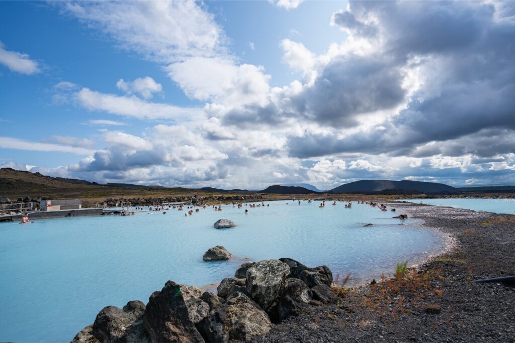 Visitors relaxing in the steaming geothermal pools of Mývatn Nature Baths, Iceland