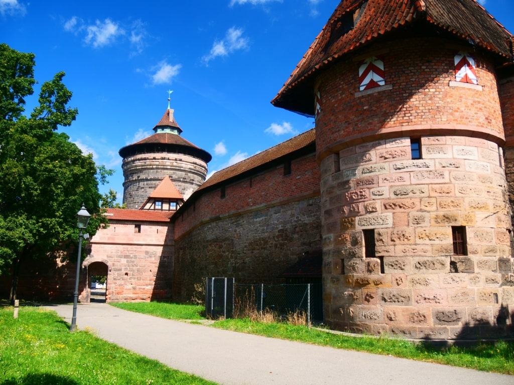 Nuremberg’s medieval city walls with defensive towers under blue sky