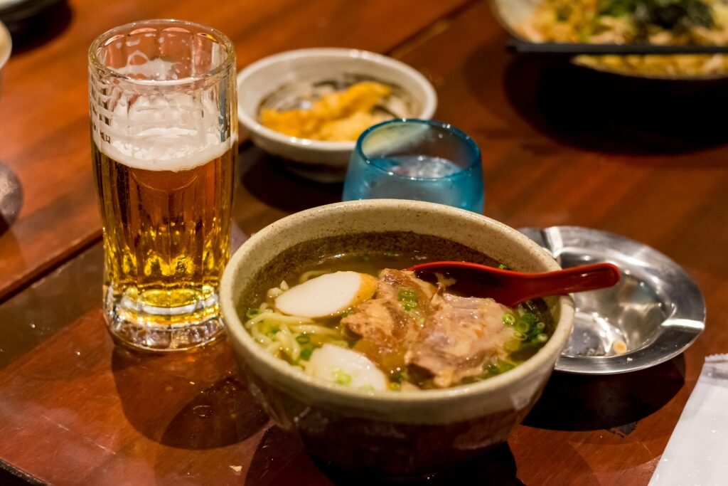 Hearty bowl of Okinawan soba with a refreshing beer for a meal