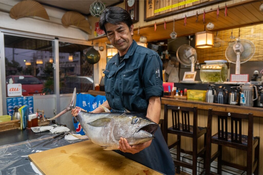 Chef performing a tuna cutting show at a restaurant in Naha, Okinawa