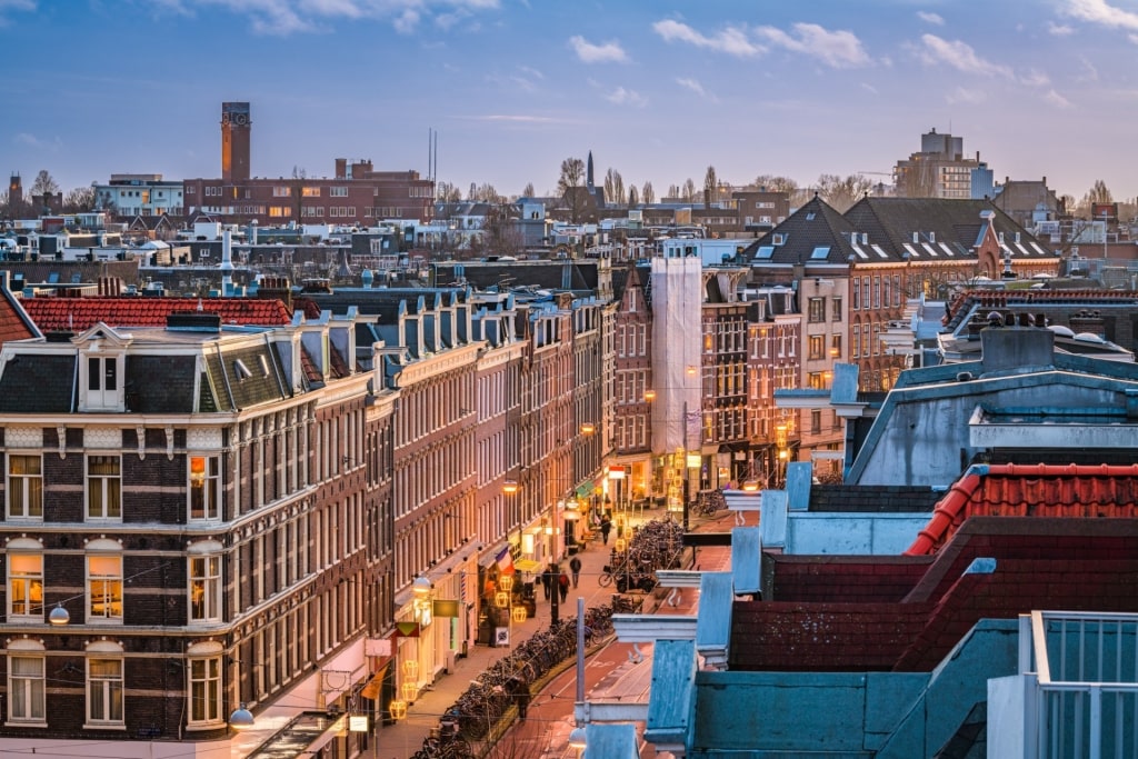 Aerial view of De Pijp neighborhood in Amsterdam with buildings and brightly lit street