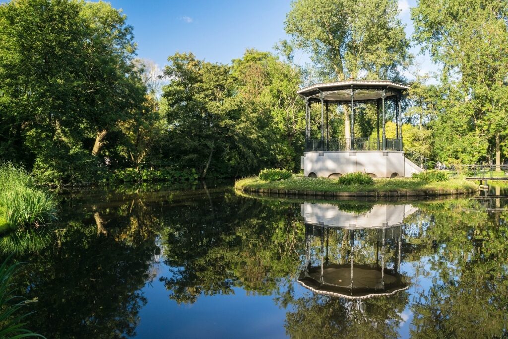 Scenic Vondelpark pond with small pavilion and surrounding greenery