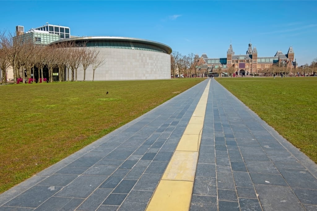 Scenic walking path toward Museumplein with green lawns and trees