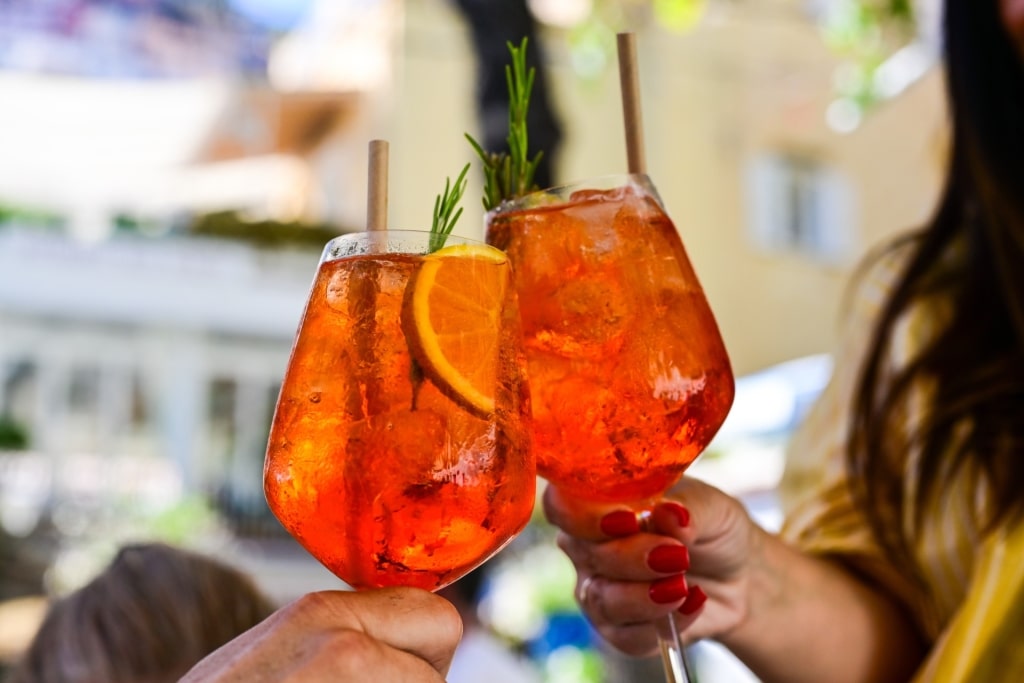 Toasting with two Spritz drinks
