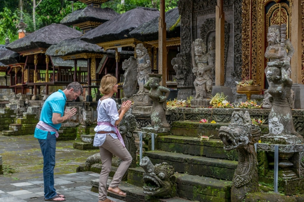 Cultural experience in Bali as tourists respectfully visits a temple
