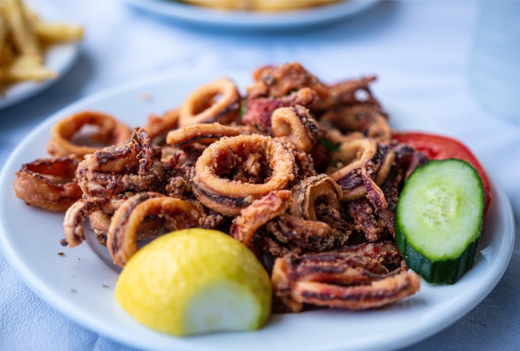 Kalamari on a plate with lemon on the side