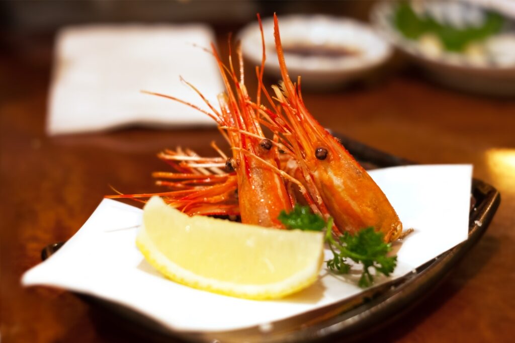 BC spot prawns on a plate with lemon on the side