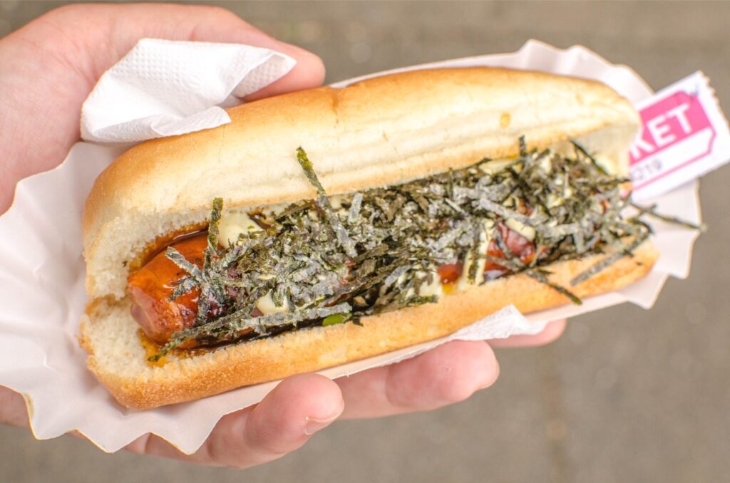 Person holding japadog street food in Vancouver