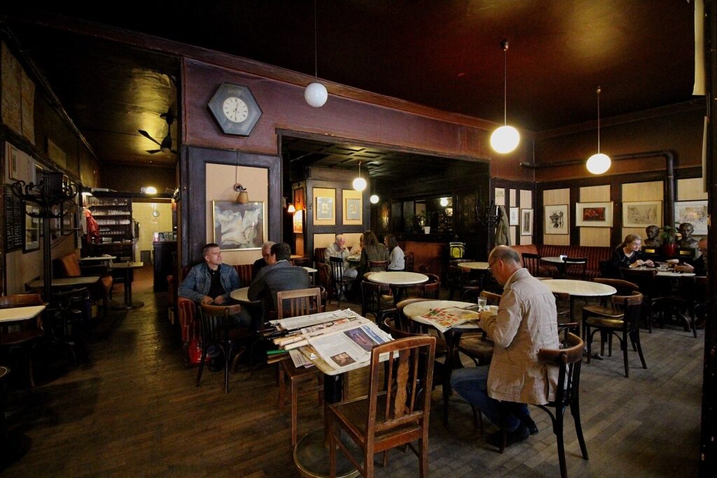 Warm, dimly lit inside view of Café Hawelka in Vienna