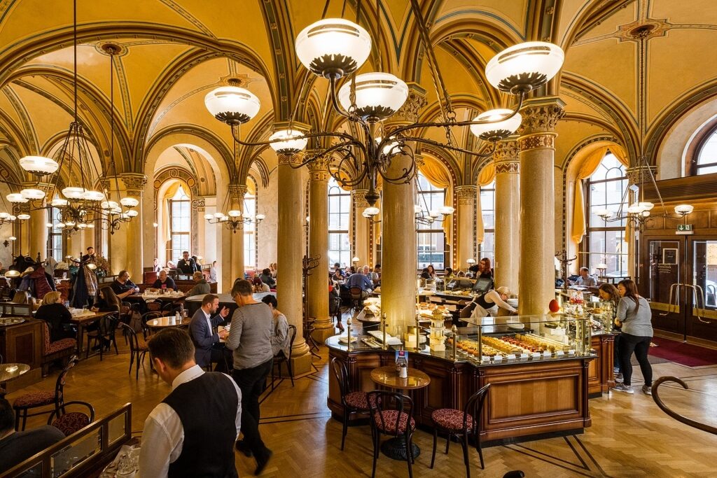 Historic interior of Café Central with arched ceilings and elegant chandeliers