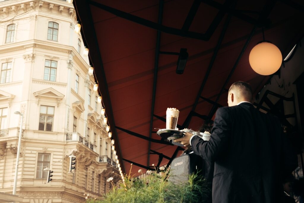 A waiter with coffee in a Vienna coffee house