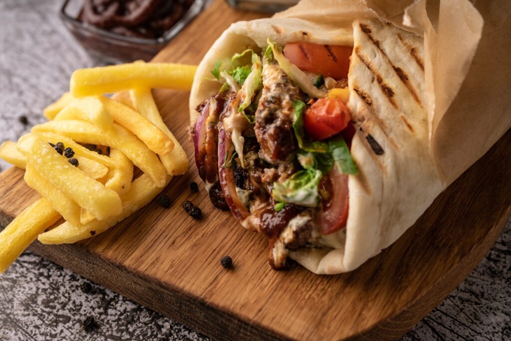 Flatbread wrap filled with Döner Kebab meat, vegetables, and sauce