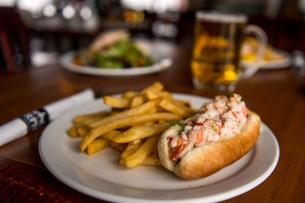 Nova Scotia seafood dish: lobster roll with crispy fries on the side