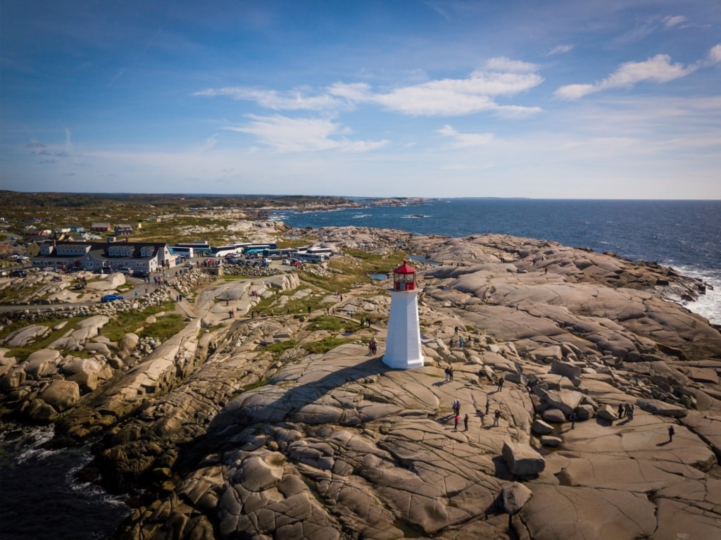 Aerial view of Peggy’s Cove lighthouse perched on rocky coastline, Nova Scotia