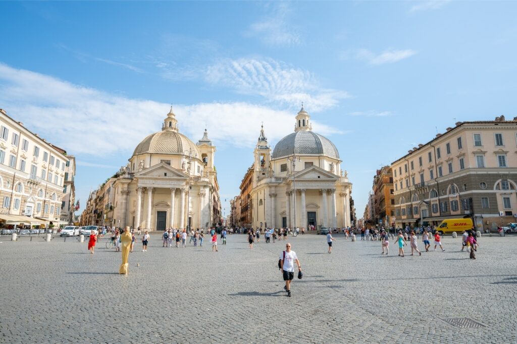 Tourists at Piazza del Popolo with twin churches in the background
