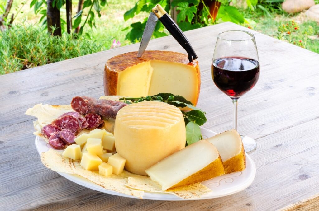 Glass of cannonau with cheese slices