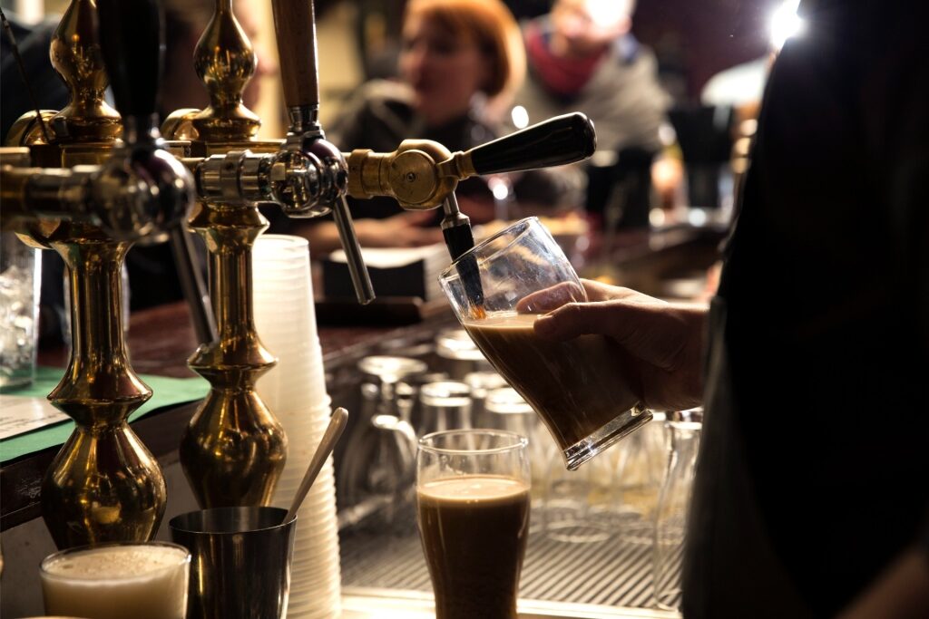 Bartender pouring beer at an Irish pub