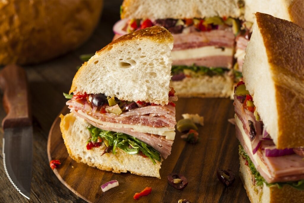 Sliced muffuletta sandwich on a plate