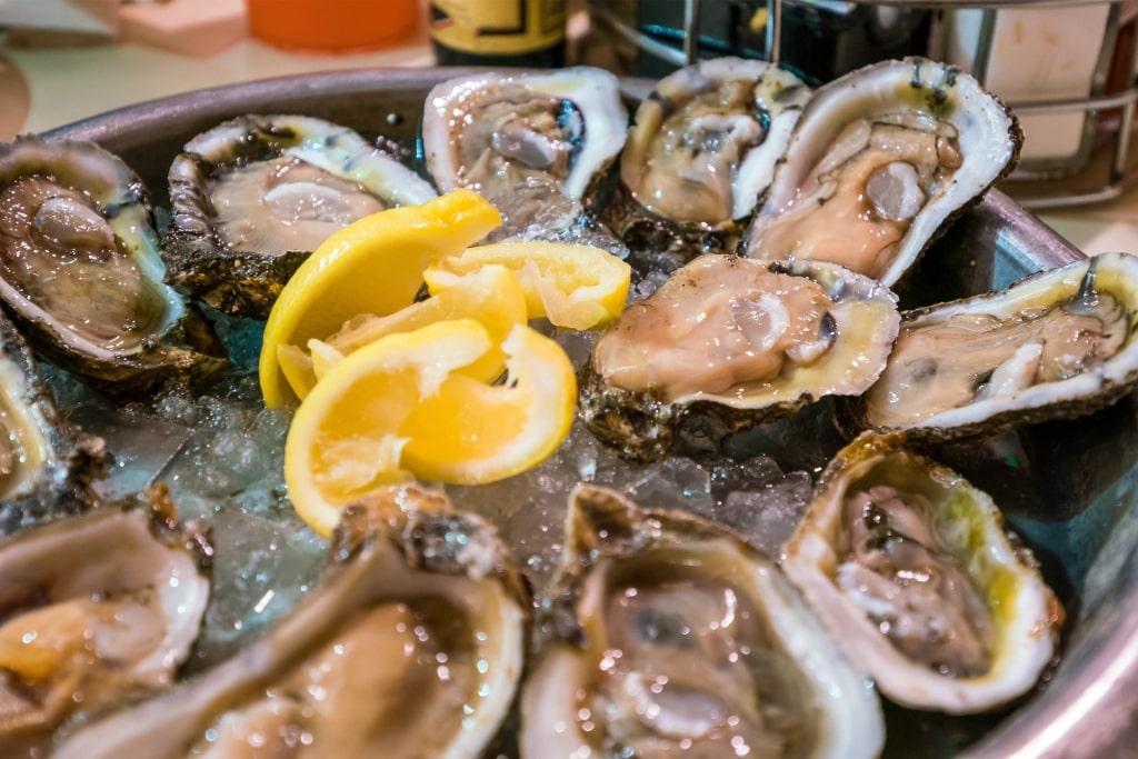 Fresh oysters on a platter with lemon slices