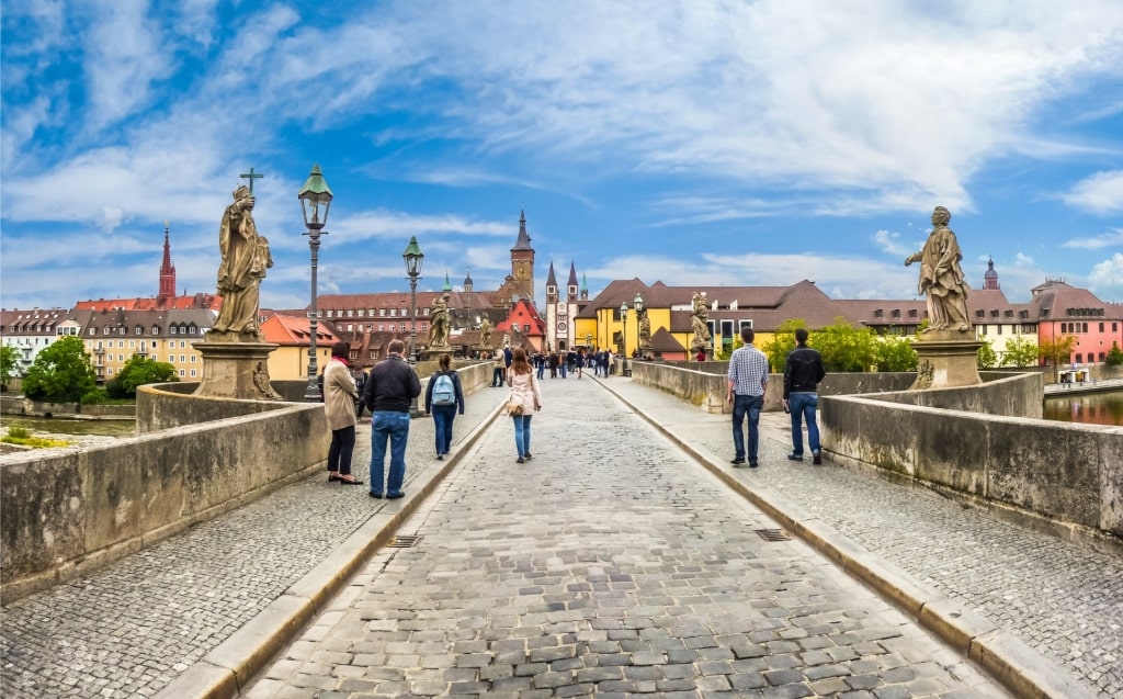 Tourists walking along the Old Main Bridge in Würzburg, Germany