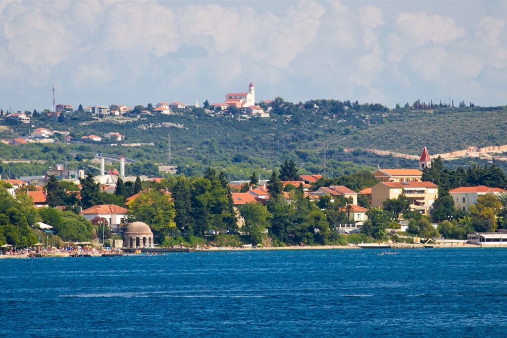 Scenic view of Kolovare Beach in Zadar, Croatia with clear waters and lush greenery