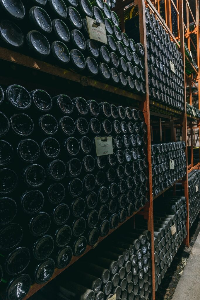 Trimbach wine bottles resting on a shelf