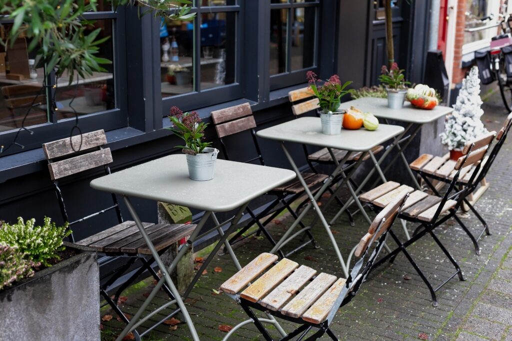 Outdoor tables with chairs on cafe terrace in Amsterdam