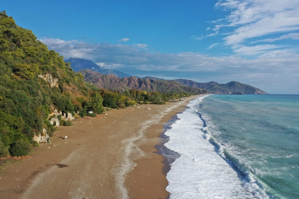 Scenic view of Çıralı Beach with turquoise waters and mountains in Antalya