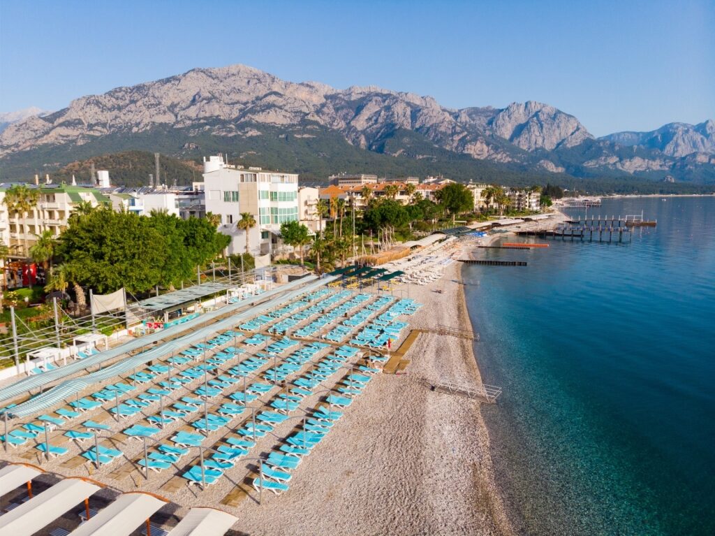 Kemer Merkez Beach lined with umbrellas and sunbeds along the Antalya coast
