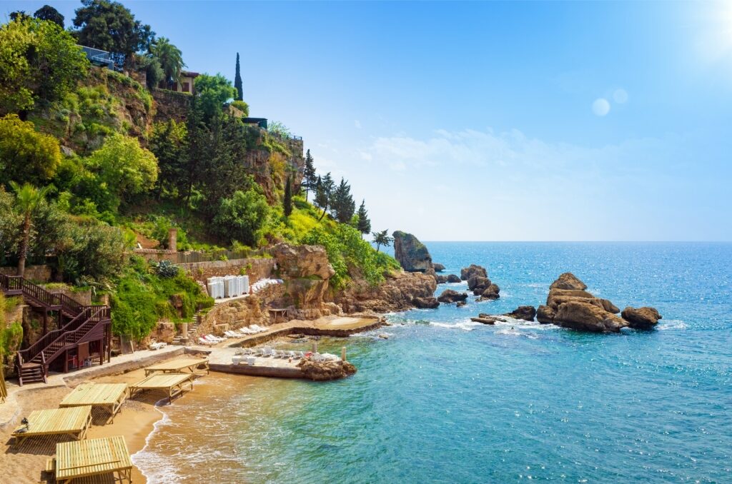 Scenic view of Mermerli Beach in Antalya with turquoise waters and rocky cliffs